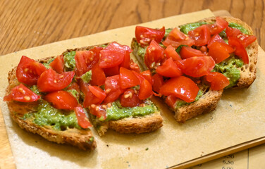 Starter in italian restaurants, bread bruschetta roasted homebaked bread with olive oil and chopped ripe tomatoes and pesto