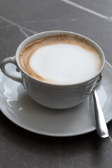 White cup of italian coffee cappuccino served in cafe in Milano, Italy