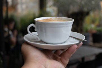 White cup of italian coffee cappuccino served in cafe in Milano, Italy