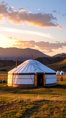 Mongolian yurt at sunset over rolling hills