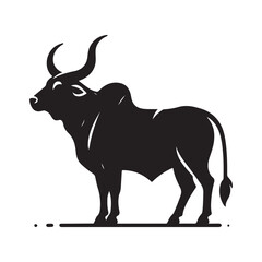 Silhouette of a majestic bull with prominent horns standing on a grassy field