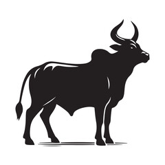 Silhouette of a majestic bull with prominent horns standing on a grassy field