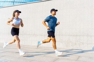 Fototapeta premium Couple jogging on a modern urban path during their morning workout