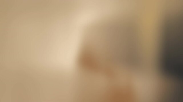 Soft hazy beige glow centers a bright diffuse light amid warm, indistinct shapes, softly blurred dim