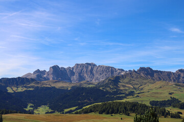 Sunlit alpine plateau with the majestic Dolomites rising behind