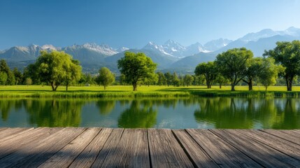 Obraz premium A serene wooden dock overlooks a calm lake, with lush green trees and majestic mountains under a clear blue sky in the background