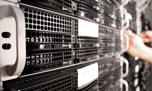 Professional IT support team working together in a network server room