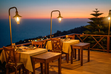 Empty restaurant table set for two, waiting for guests at sunset.

