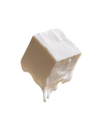 Creamy, cube-shaped food item, dripping slightly