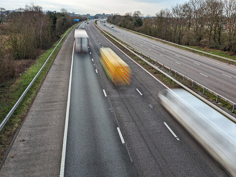 Speeding freight vehicles on the M5 motorway towards Exeter, UK.  Selective Focus for accentuation