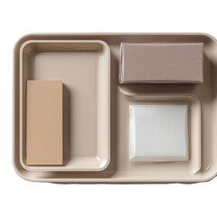 Beige tray with three compartments holding rectangular items