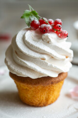 Red currant cake and a cup of aromatic tea in a porcelain cup on the table.