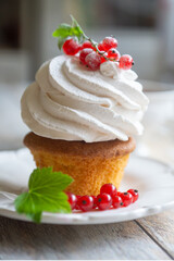 Red currant cake and a cup of aromatic tea in a porcelain cup on the table.