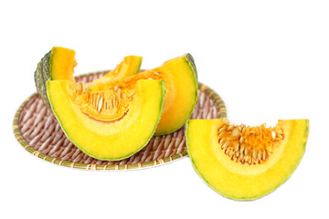 Fresh slices of pumpkin with seeds on a bamboo tray, isolated on white background. Healthy organic vegetable rich in vitamins and fiber, ideal for cooking, diet, and natural food concepts.