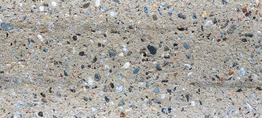 Exposed aggregate concrete in wall close-up 