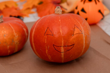 Carving smiling faces on pumpkins for Halloween celebration at home