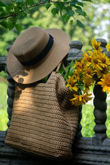Wild flowers in a beautiful straw bag and a straw hat.