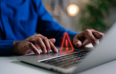 A Businessman working and using laptop computer with triangle caution warning sign for notification...