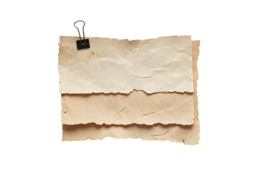 Vintage paper sheets held together by a binder clip, isolated on a white background, evoking a sense of nostalgia and historical documentkeeping