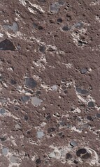 Abstract Textured Surface with Granular Reddish-Brown Matrix and Smooth Multi-Colored Pebbles