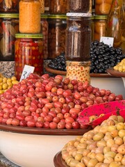 Different types of olives on the market in Morocco, olives in jars, different flavors