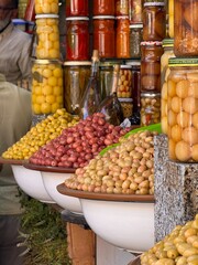 Olives on the counter at the Moroccan market, olives in jars, different flavors