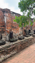 Wat Chaiwatthanaram in Ayutthaya, Thailand. Scenic ruins of the Buddhist temple in the ancient city. Parts of Buddha statues.