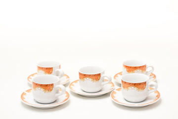 Elegant coffee cups with intricate orange patterns, perfect for breakfast or afternoon tea