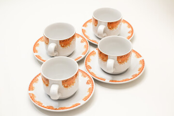 Elegant coffee cups with saucers, arranged in a minimalistic, clean composition