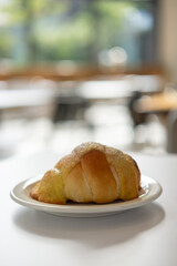 Salted bread with sweet sauce on the top, served on plate on the table
