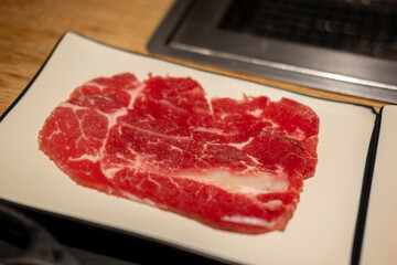 Korean Style Barbecue on plate. BBQ rare meat with soft focus