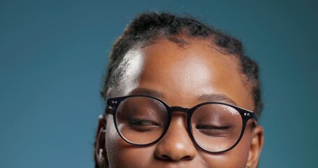 Glasses, eyes and looking up with black woman in studio for vision health, announcement and idea. Mockup space, lens prescription and promotion with person on blue background for frames and eyewear