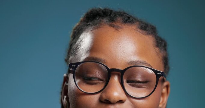 Glasses, eyes and looking up with black woman in studio for vision health, announcement and idea. Mockup space, lens prescription and promotion with person on blue background for frames and eyewear