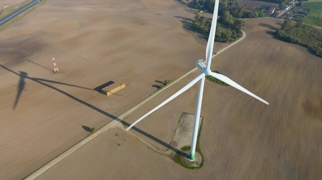 Aerial Drone View of Wind Turbine Generating Renewable Energy over Farmland