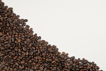 Coffee beans, close-up with copy space on a white background, studio shot