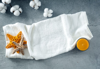Obraz na płótnie Canvas Terry white towel top view spa products showcase. Summer resort scin care and relax treatment background,backdrop. Sea bath bodycare products display.