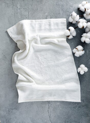 Terry white towel top view spa products showcase. Summer resort  scin care and relax treatment background,backdrop. Sea bath bodycare productsvertical display.