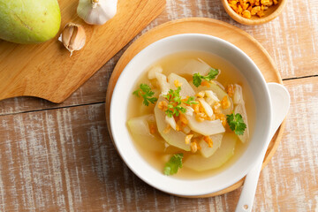 Winter Melon Soup with sun dried shrimp in white bowl.Thai gourd soup is a nutritious and refreshing and low calorie count.Top view.