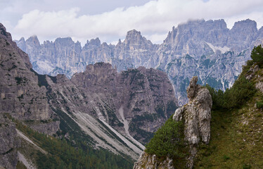 The mountain landscape of inaccessible and wild Friuli Dolomites, UNESCO Heritage. Nature reserves Dolomiti Friulane and Forra del Cellina. Layers of distant mountain ranges. Autumn, mist, rain clouds
