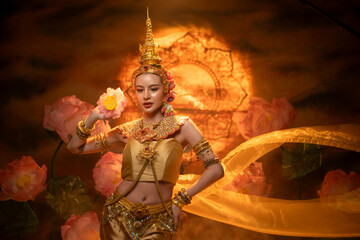 Fototapeta premium A beautiful woman in traditional Thai costume performing a classical dance