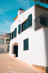 White Mediterranean house with blue shutters and balcony in Begur, Catalonia, Spain