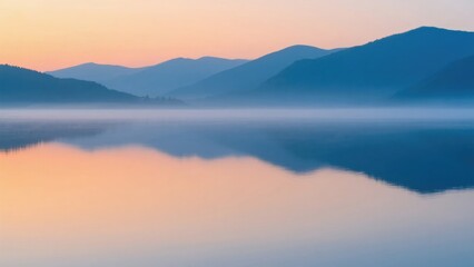 Obraz premium Serene lake with mountain reflection at dawn