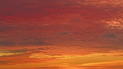 Dramatic Cloudscape of Sunset Radiance Above Karon beach. A fiery sunset sky glows with deep reds and golden hues, painting the horizon with warmth and serenity as twilight embraces the evening.