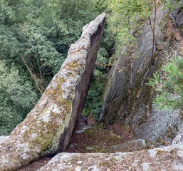 Steep rock formation in a forested landscape
