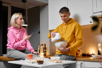 Couple Preparing a Meal in a Cozy Home Kitchen Setting