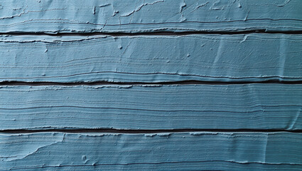 Textured blue paint on wooden surface