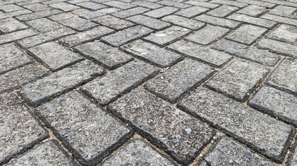 Herringbone paving block pattern showing geometric alignment and durable surface structure.
