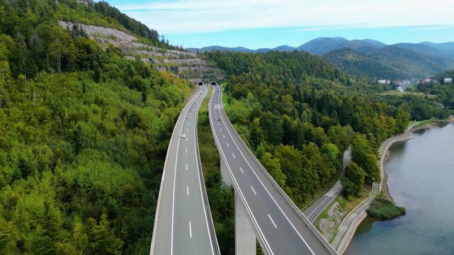 Panoramic aerial view of the toll highway (Autocesta A6) bridge near Fužine (Fuzine) and Lake Bajer in Gorski Kotar, Croatia, surrounded by green mountains and forests