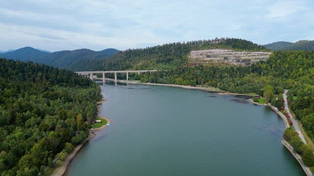 Panoramic aerial view of the toll highway (Autocesta A6) bridge near Fužine (Fuzine) and Lake Bajer in Gorski Kotar, Croatia, surrounded by green mountains and forests