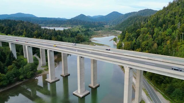 Panoramic aerial view of the toll highway (Autocesta A6) bridge near Fužine (Fuzine) and Lake Bajer in Gorski Kotar, Croatia, surrounded by green mountains and forests